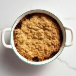 Apple crumble with a golden topping and caramelized apple filling