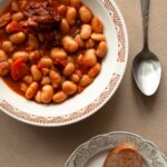 Bowl of beans in tomato sauce with bread